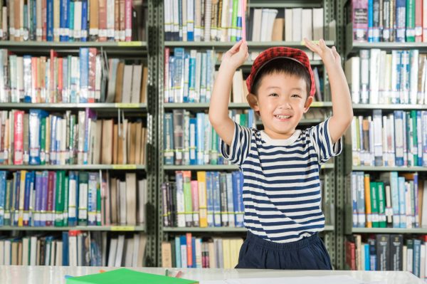 Asian Boy smiling in library room school